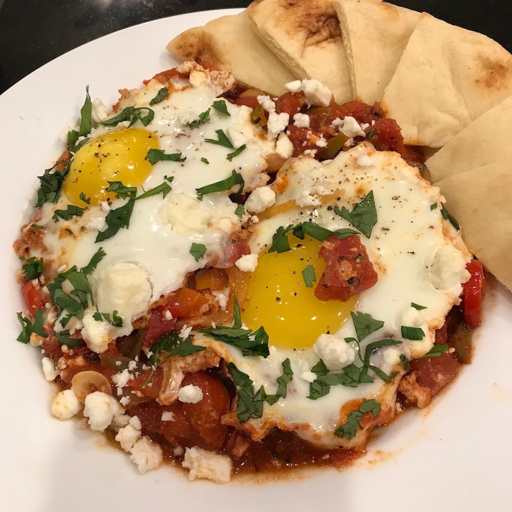 Shakshouka with Pita Bread recipe including feta cheese and baked eggs