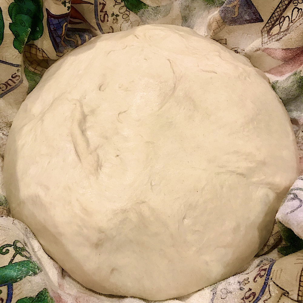 shaped sourdough bread dough in proofing basket