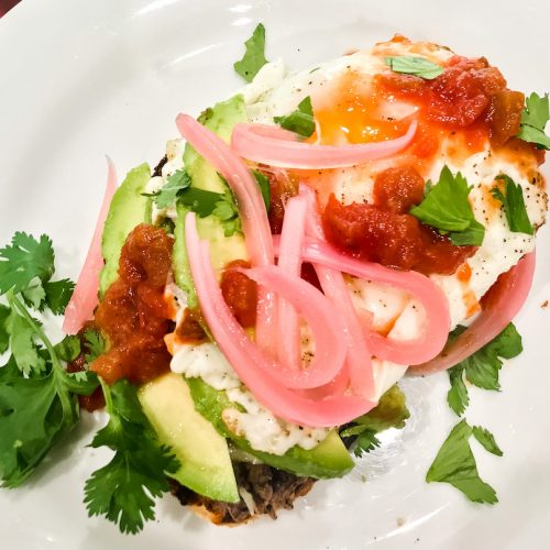 refried black bean molletes toast with pickled red onion and avocado